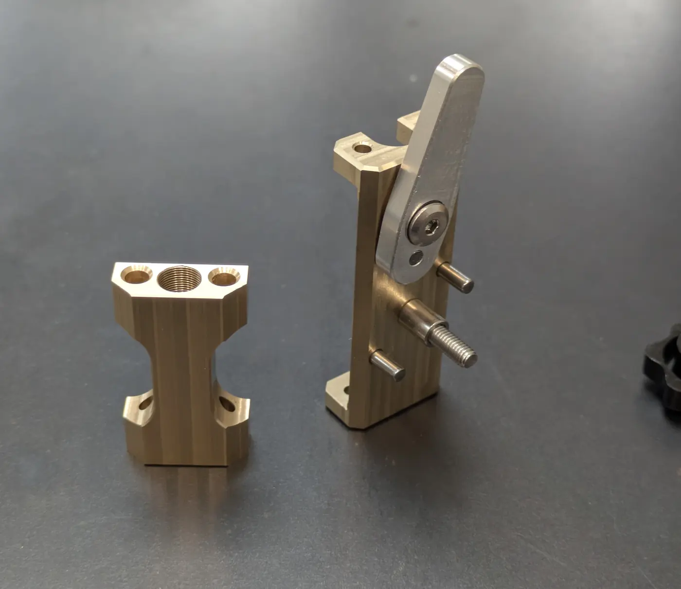 Two machined components on a work surface