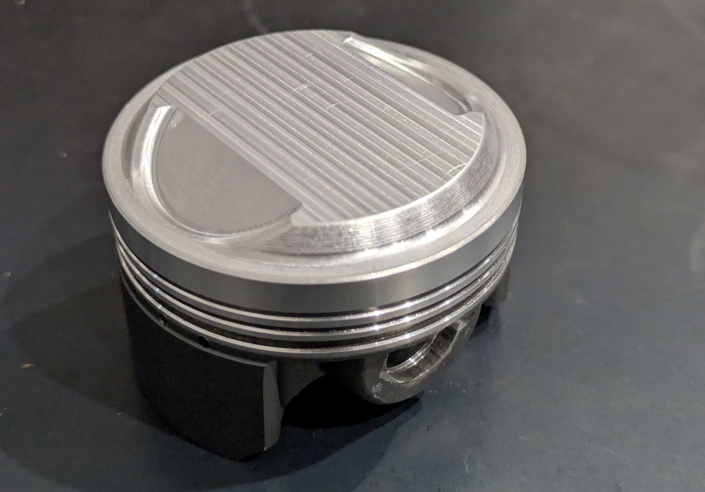 Finished machined metal component on a dark work surface