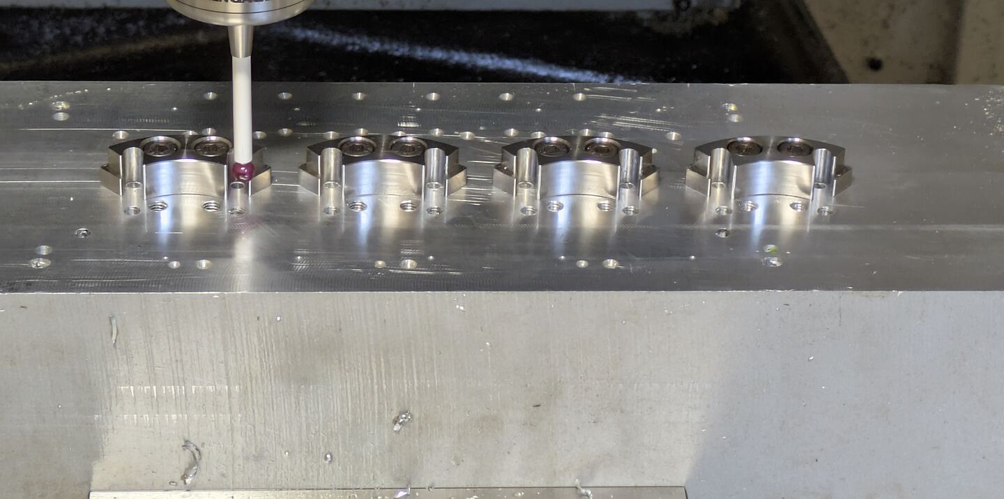 Inspection probe positioned above machined components